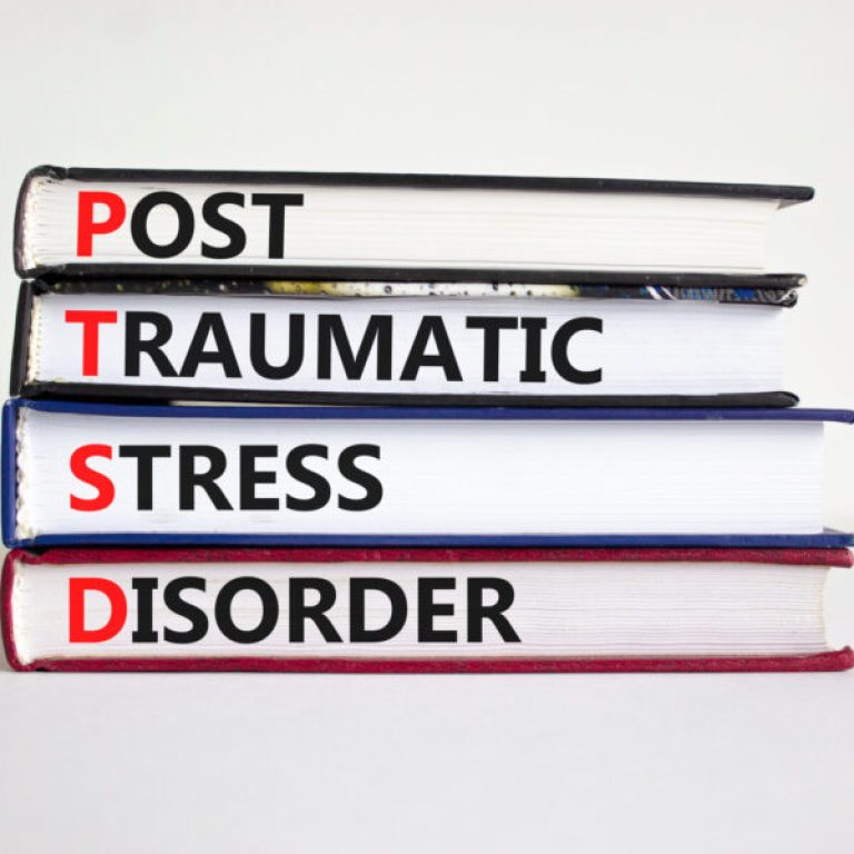 PTSD, post-traumatic stress disorder symbol. Concept words 'PTSD, post-traumatic stress disorder' on books on a beautiful white background. Medical and PTSD concept. Copy space.